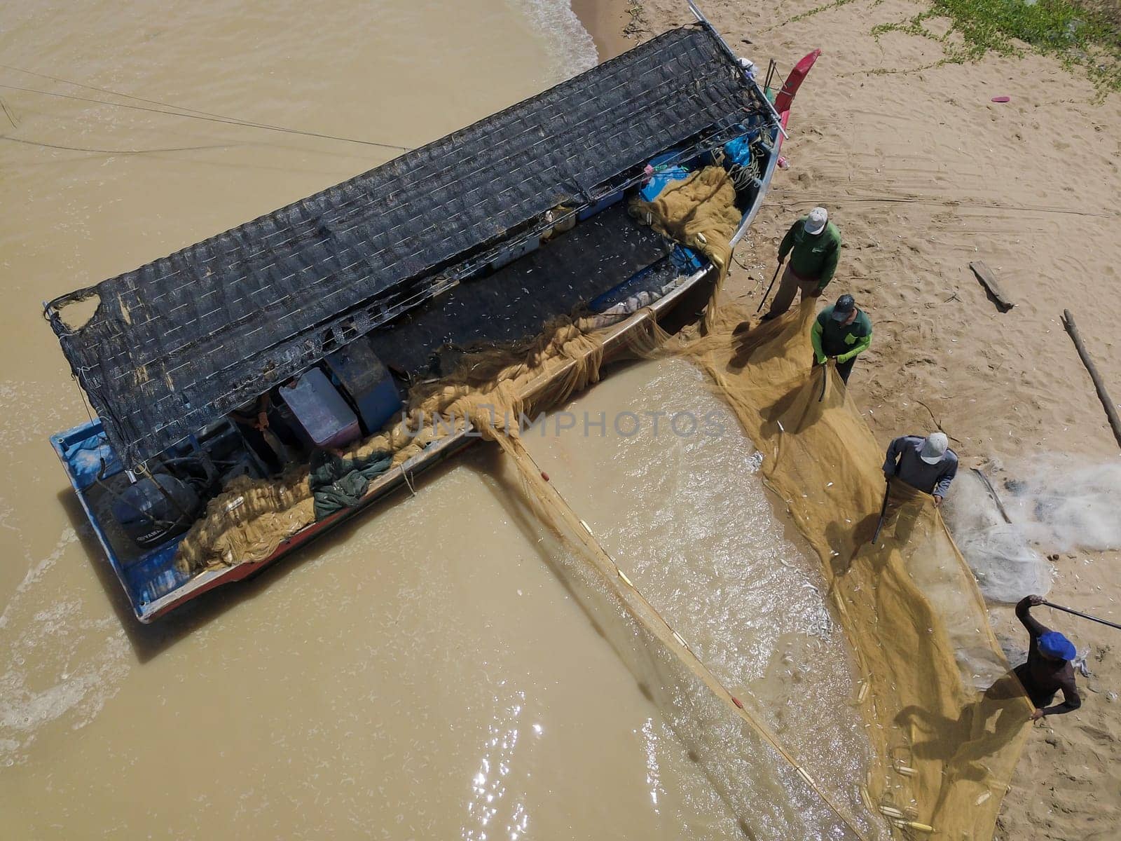 Penaga, Penang/Malaysia - Oct 27 2019: Aerial view fisherman cleaning the net near beach.