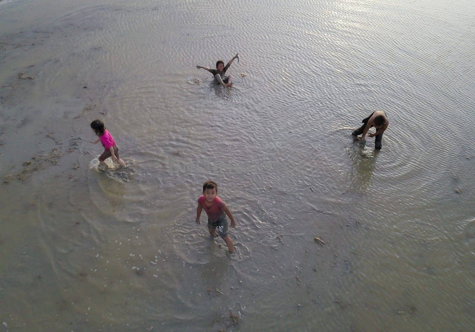 Penaga, Penang/Malaysia - Nov 03 2019: Asian Malays children play muddy in paddy field.