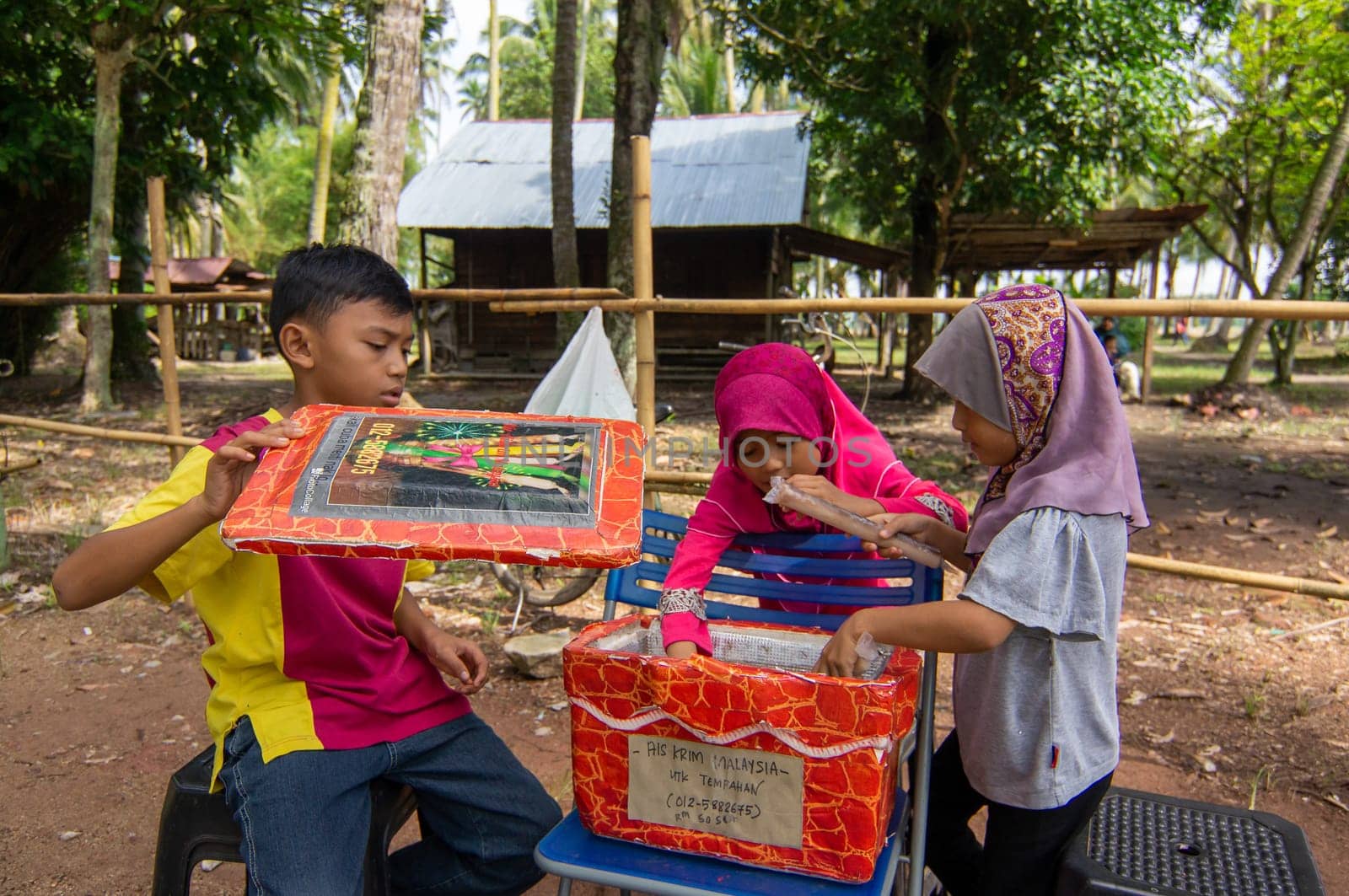 Penaga, Penang/Malaysia - Oct 27 2019: Kids sell ice cream at Kampung.
