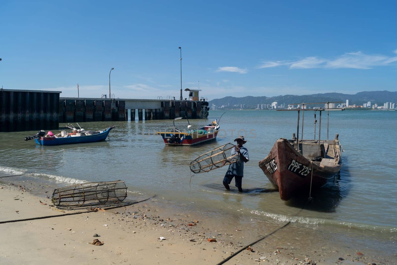 Butterworth, Penang/Malaysia - Jan 01 2020: Fisherman carry fish trap.