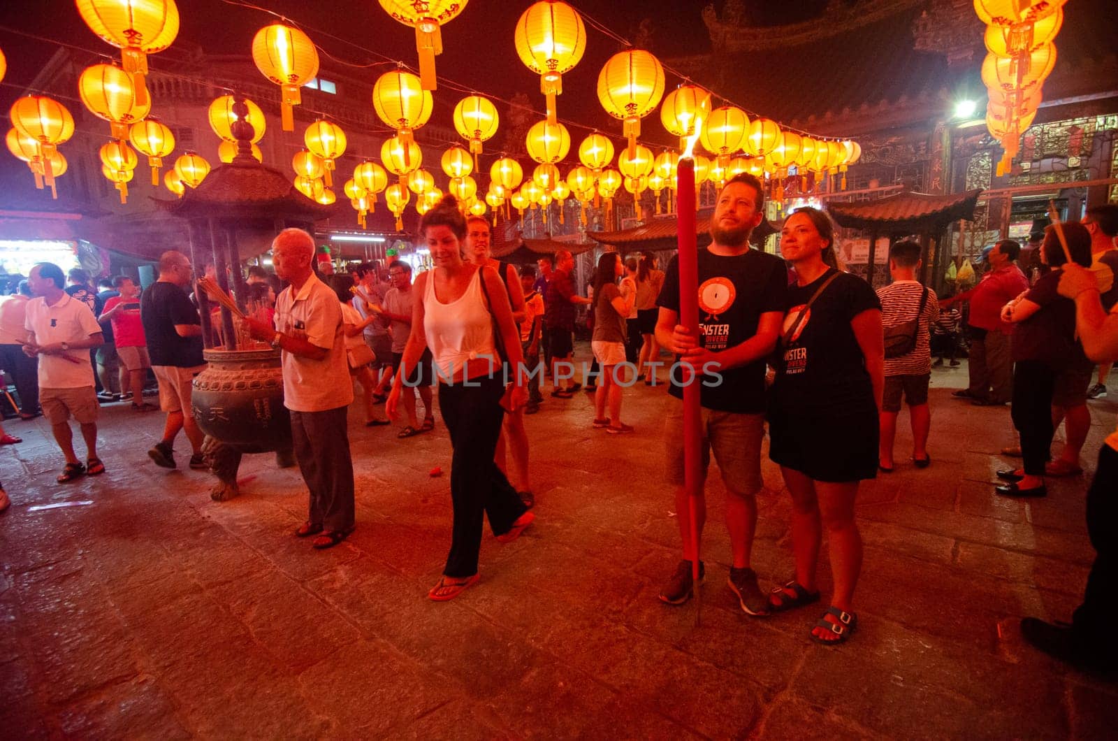 Georgetown, Penang/Malaysia - Jan 24 2020: Foreign pray with large joss stick at Goddess of Mercy temple.