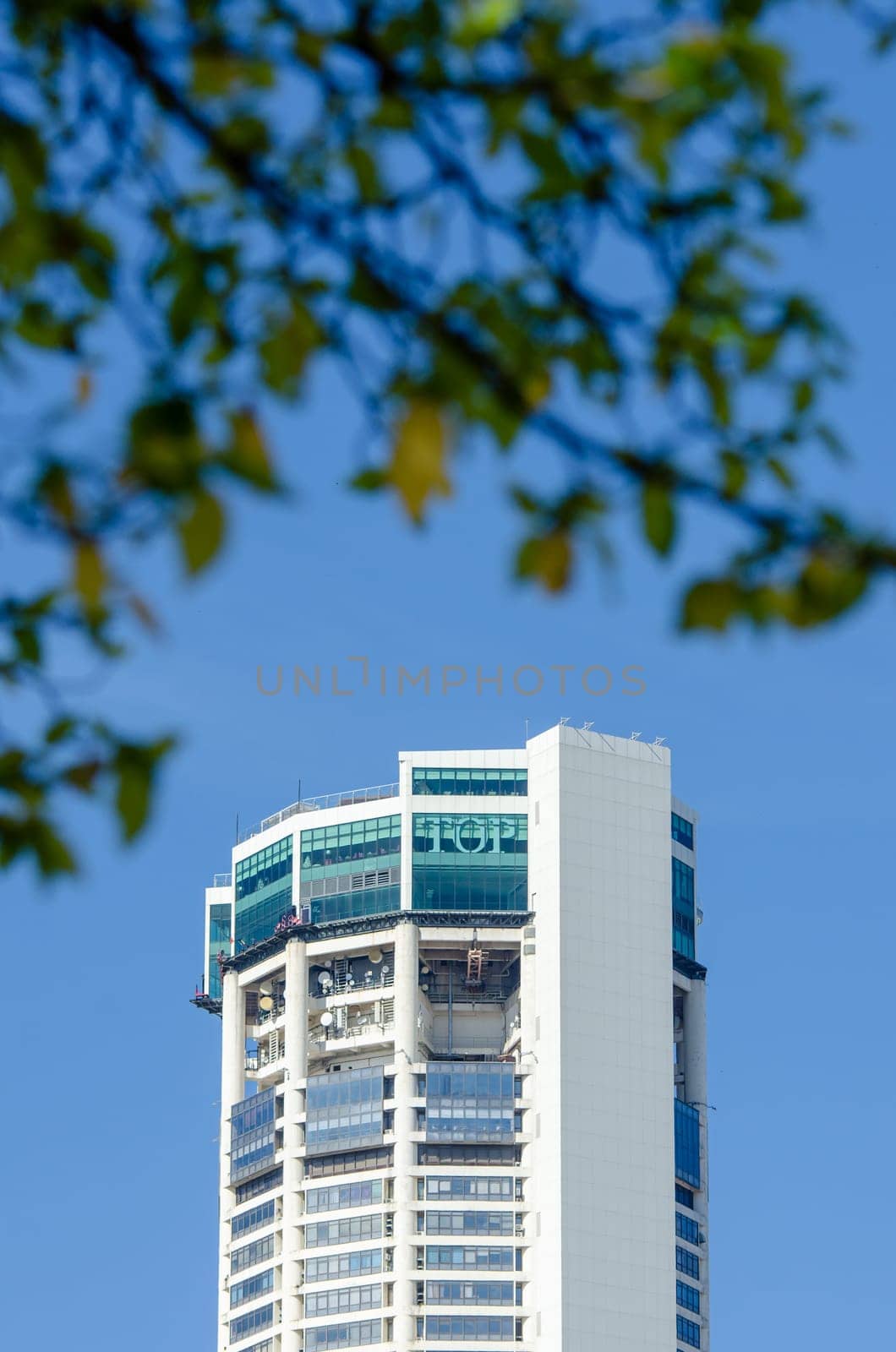 Georgetown, Penang/Malaysia - Jan 03 2020: Penang highest building KOMTAR. Foreground is green leaves.