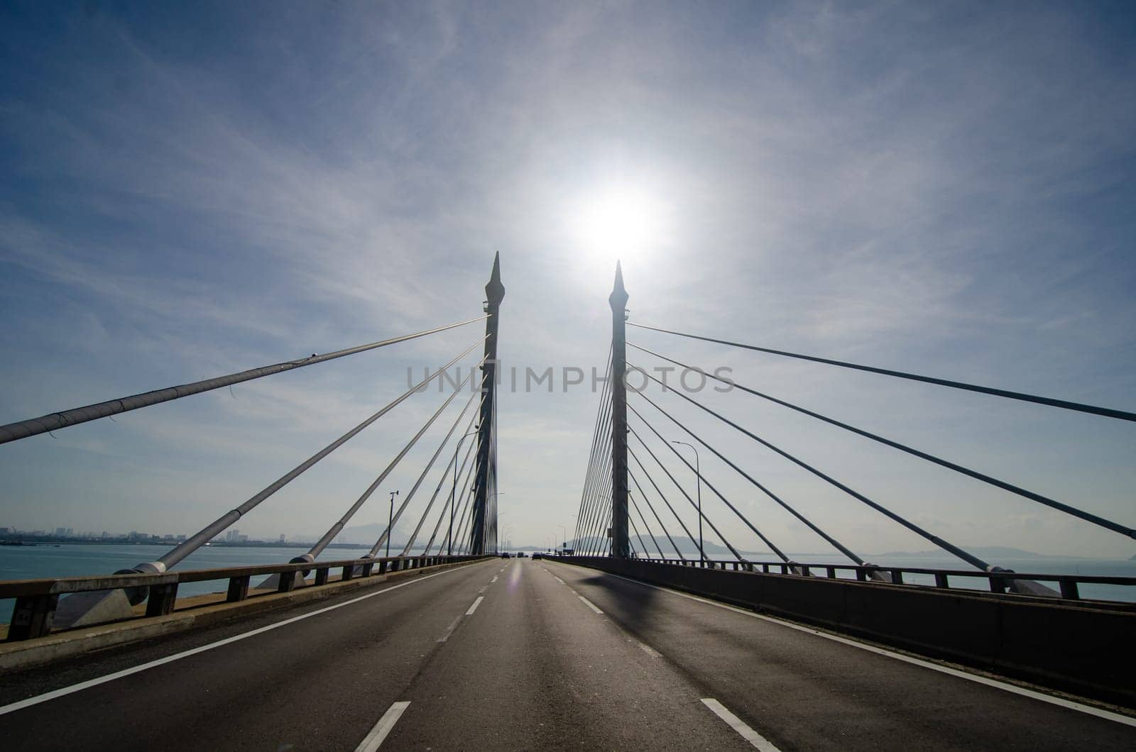 Georgetown, Penang/Malaysia - Feb 16 2020: Penang Bridge with sun at the back.