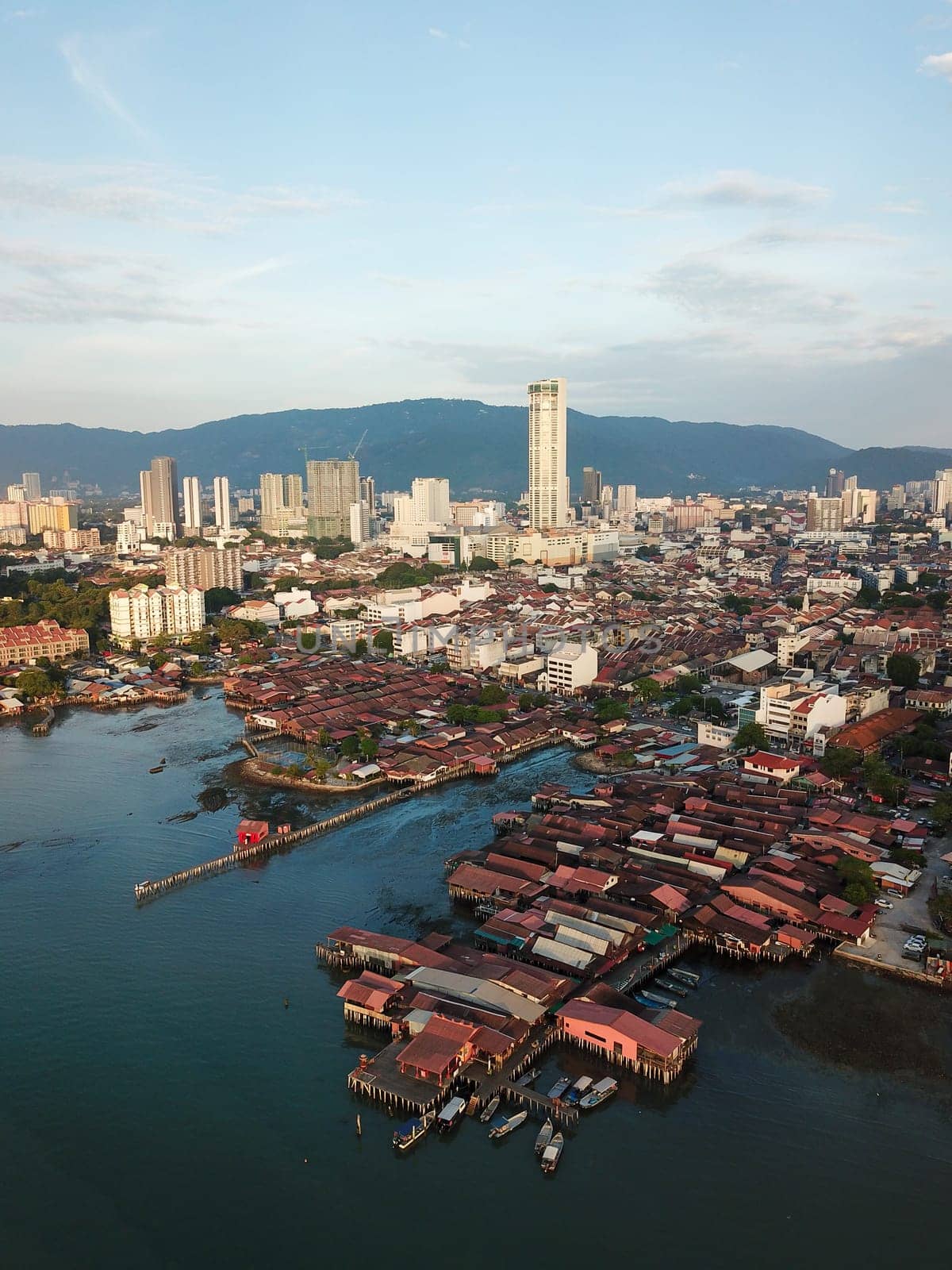 Georgetown, Penang/Malaysia - Feb 28 2020: Aerial Clan Jetty wooden house with background KOMTAR building.