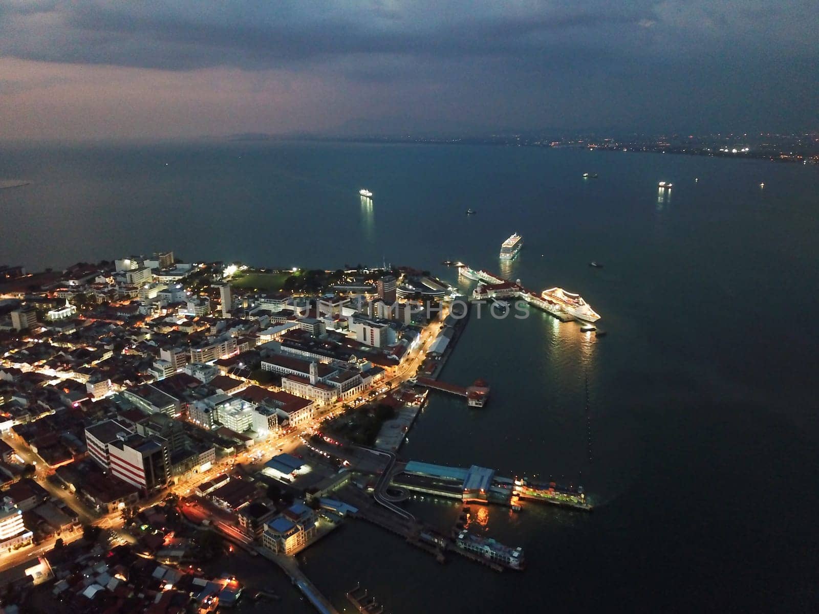 Georgetown, Penang/Malaysia - Feb 28 2020: Night scene at Pengkalan Weld at Georgetown with ferry and cruise anchor.