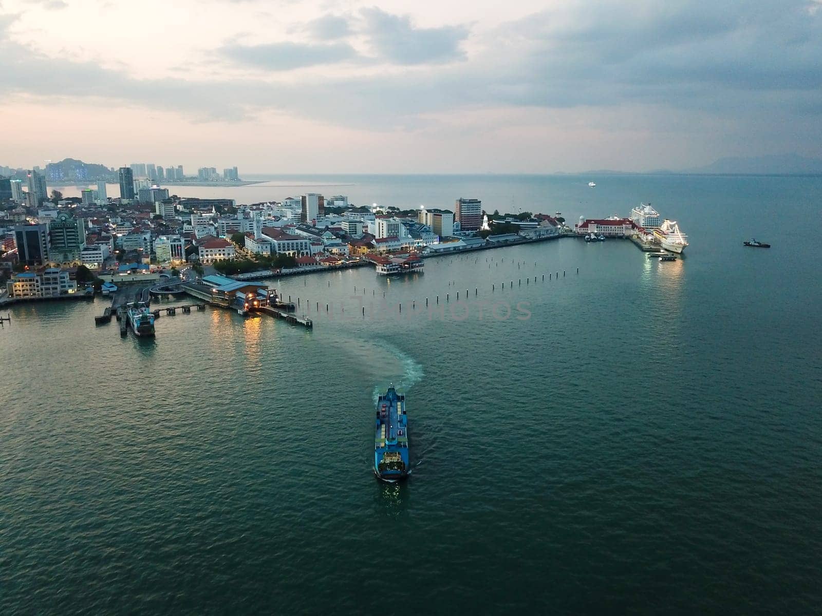 Georgetown, Penang/Malaysia - Feb 28 2020: Aerial view blue ferry leave terminal Georgetown at night.
