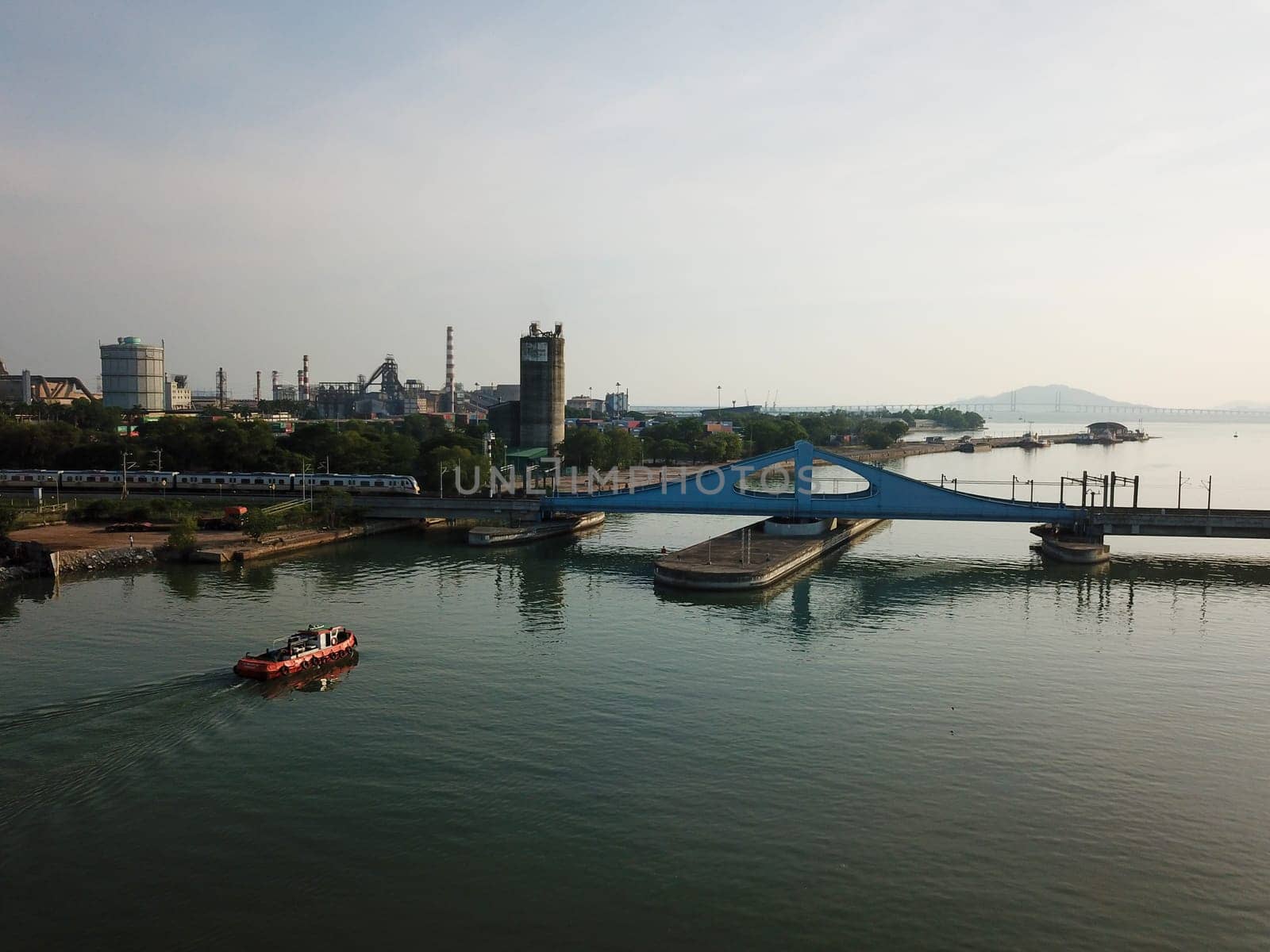Perai, Penang/Malaysia - Mar 02 2020: A tugboat is move toward Prai River Swing Bridge