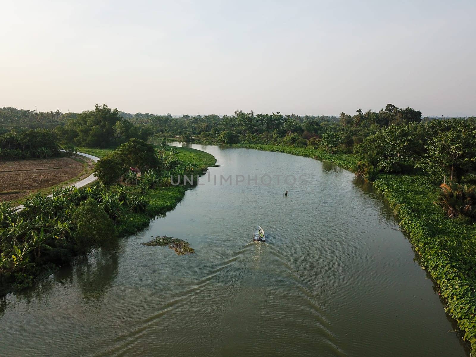 Penanti, Penang/Malaysia - Mar 01 2020: Aerial view boats move at Sungai Perai near rural area.