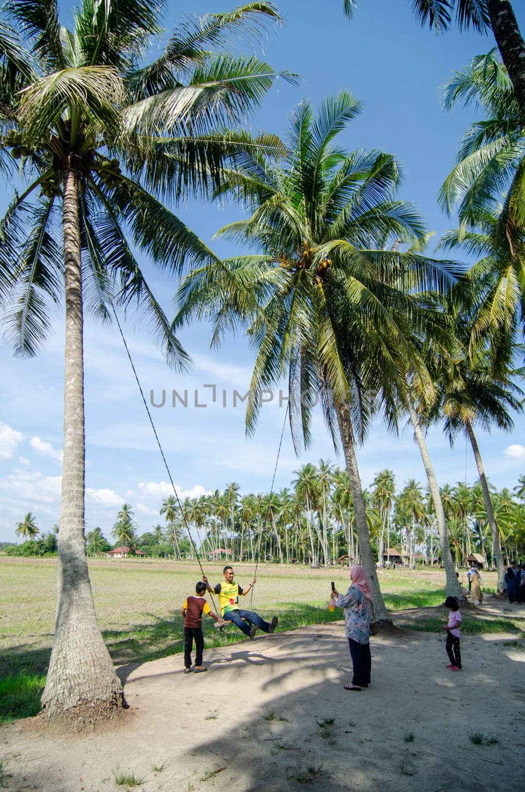 Penaga, Penang/Malaysia - Mar 15 2020: Tourist play swing in Kampung Agong.
