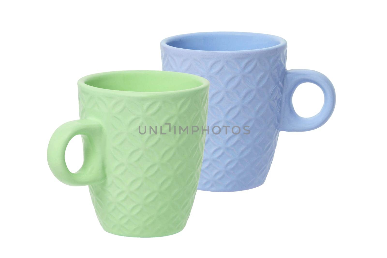 Mug of coffee. Closeup of a green and a blue ceramic mug or tea cup isolated on a white background. Macro.