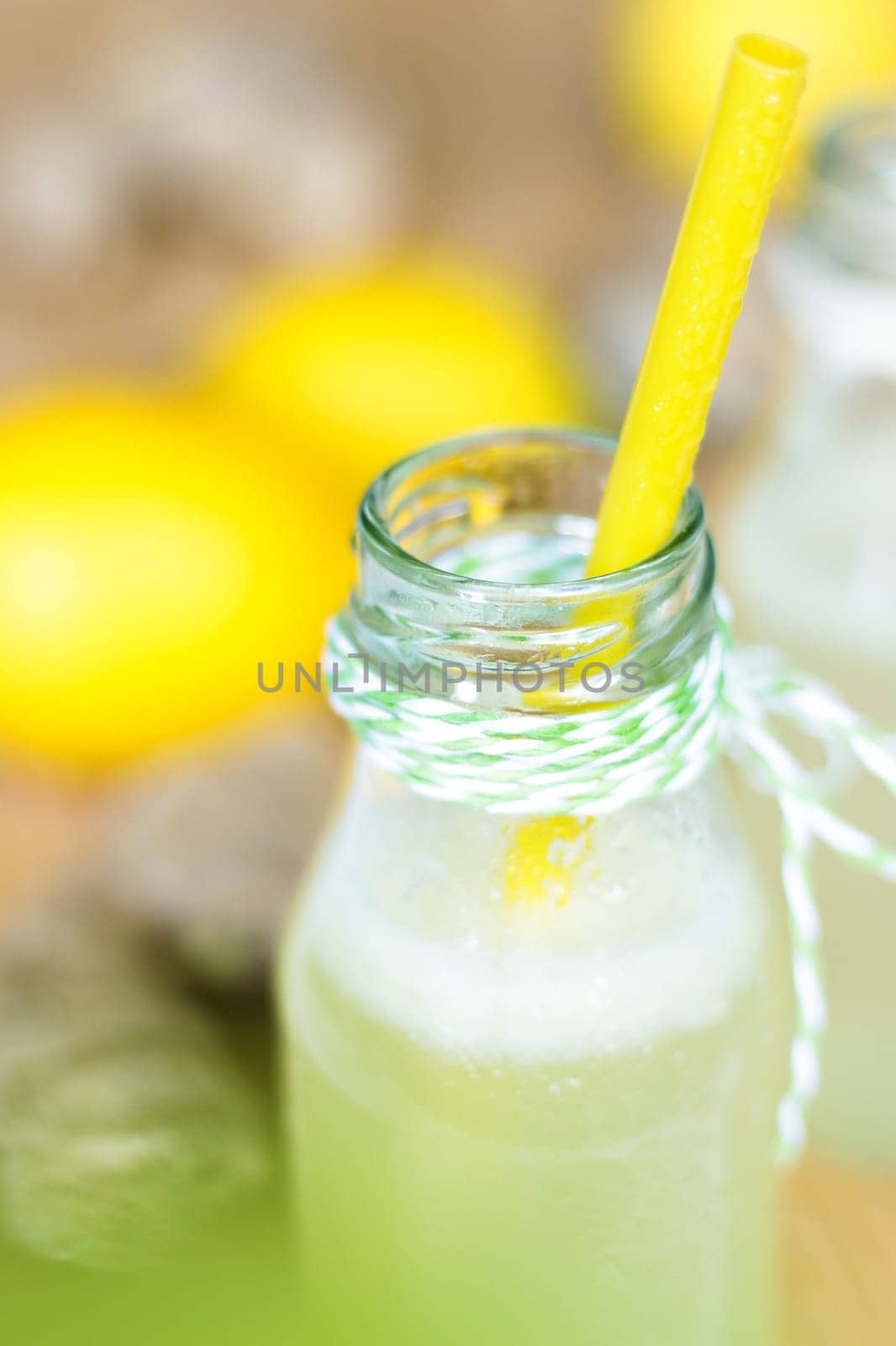 Cool lemonade with ginger, lime and lemon in a small bottle