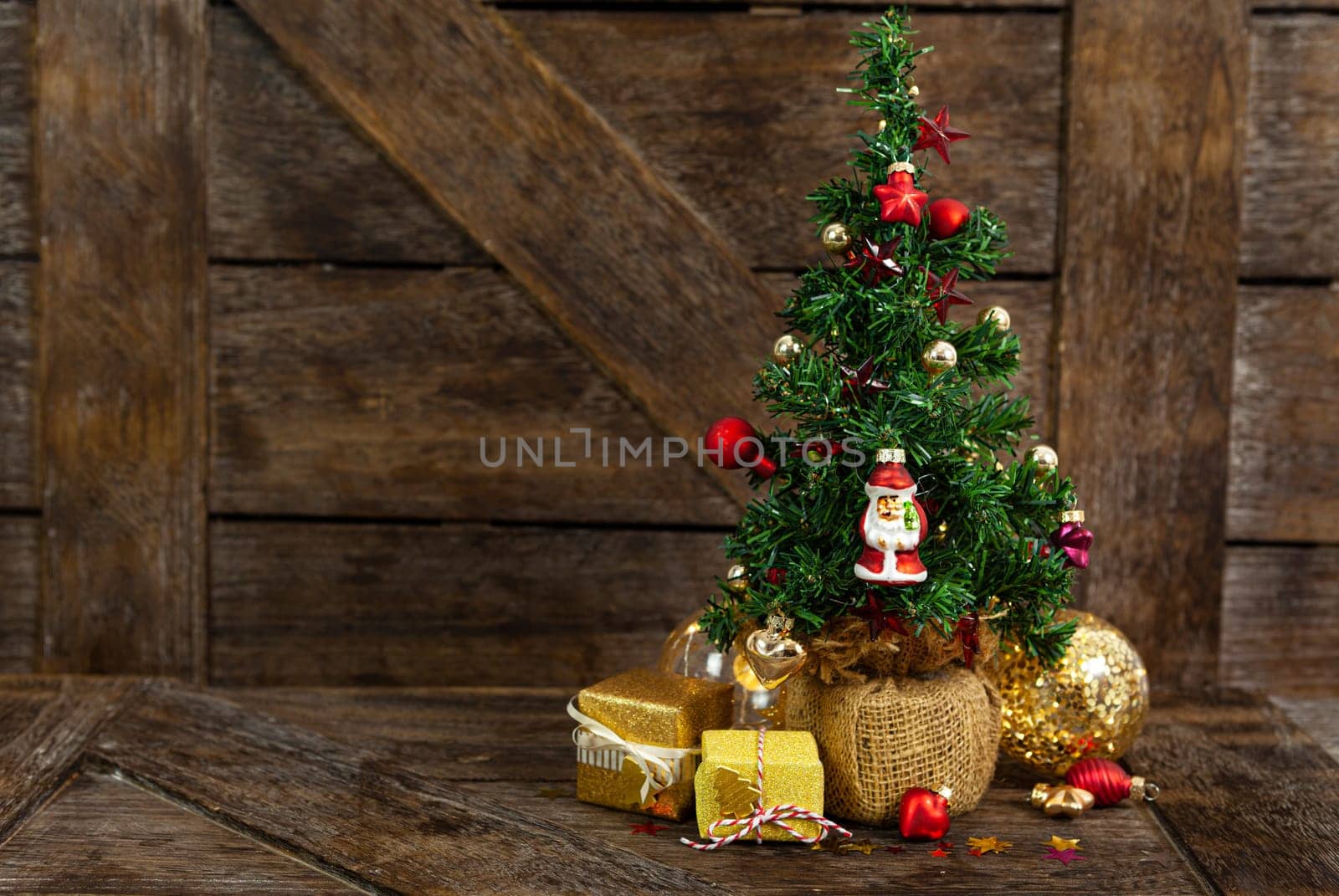 Little decorated Christmas tree with little presents