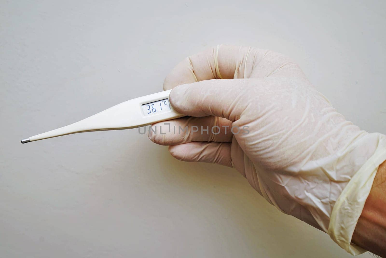 Doctor hold medical digital thermometer in hand on white background