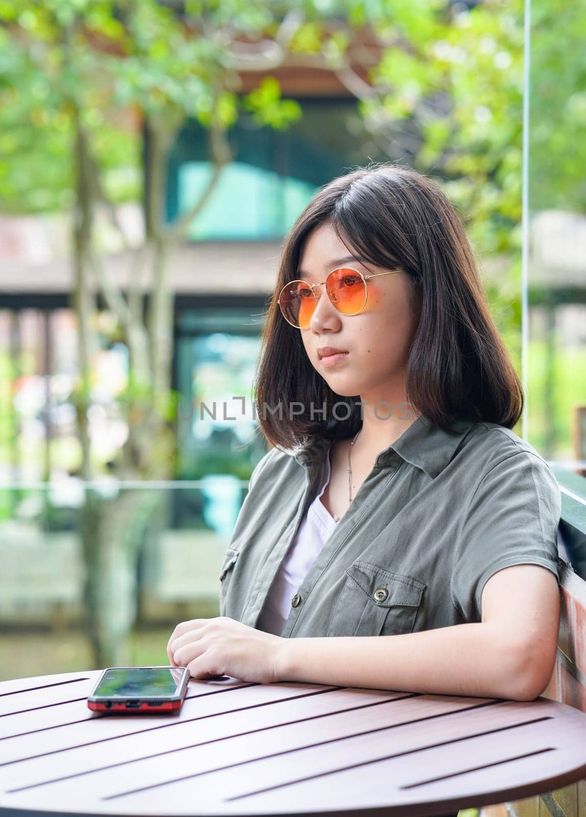 Pretty woman sitting in a cafe terrace use smartphone