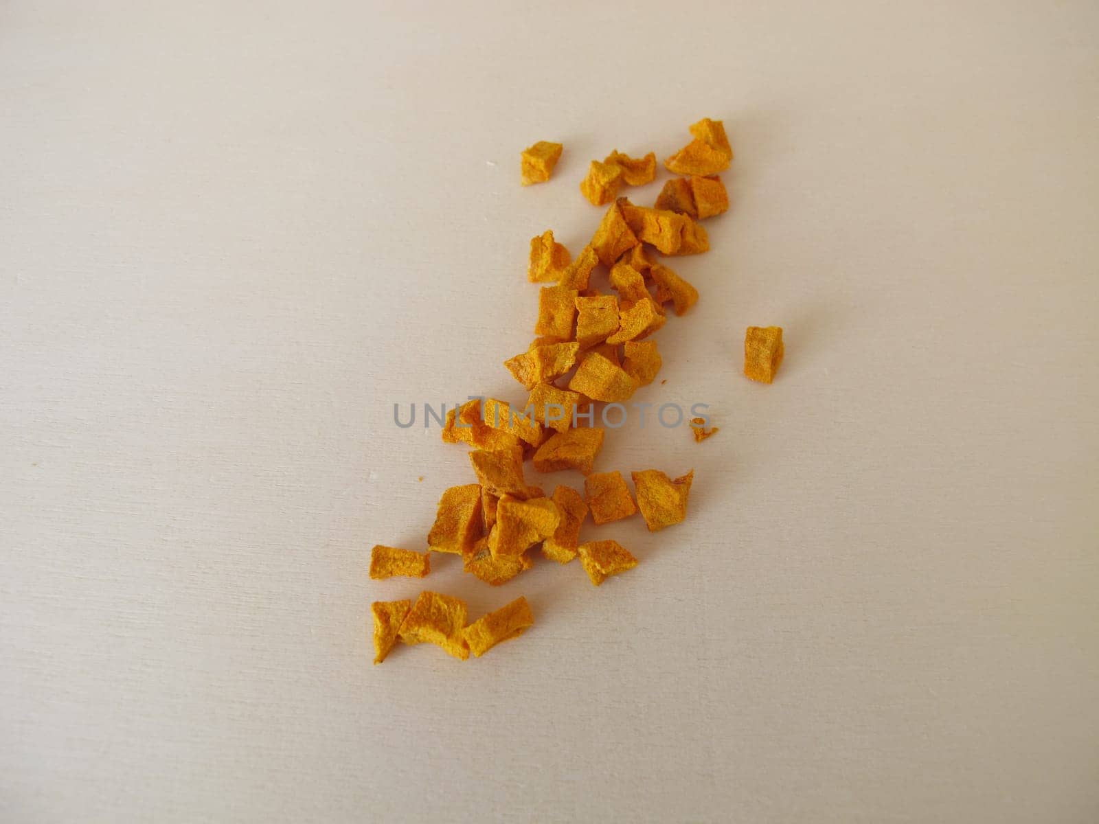 Dried turmeric, curcuma root on a wooden board