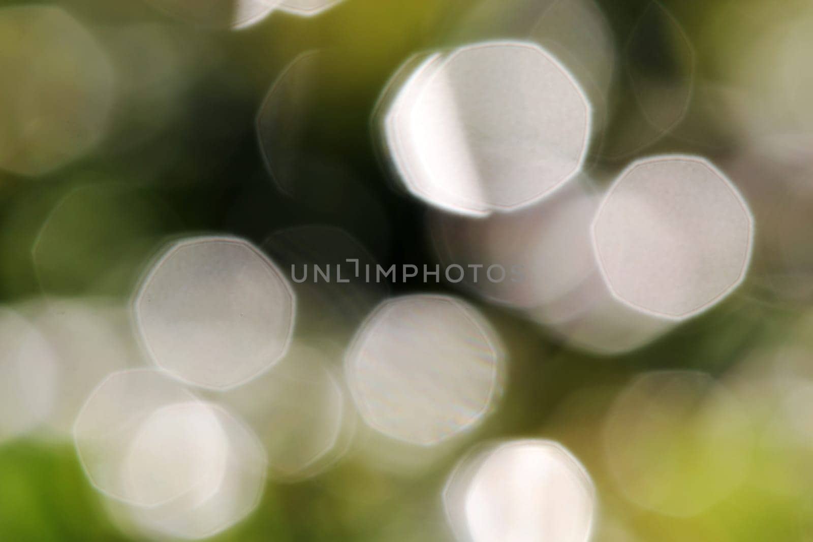 Glittering blurred green and white background with luminous dots