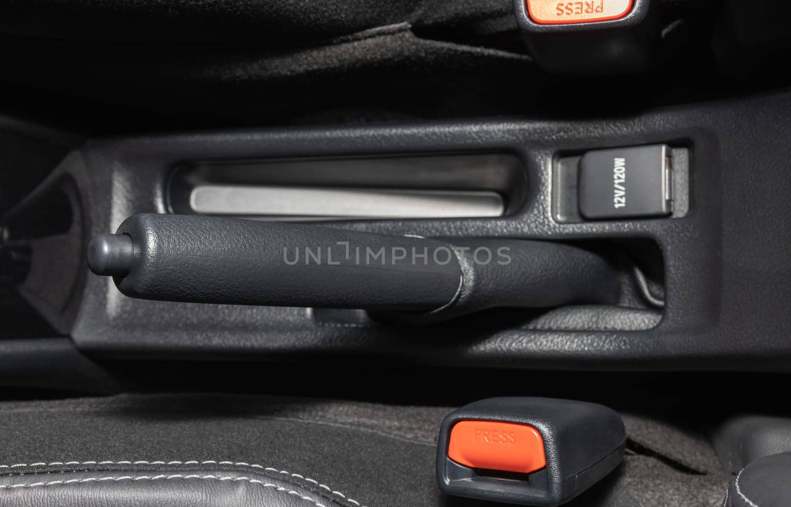 Gray Hand Brake and Seatbelt Lock Inside Car on Center Frame