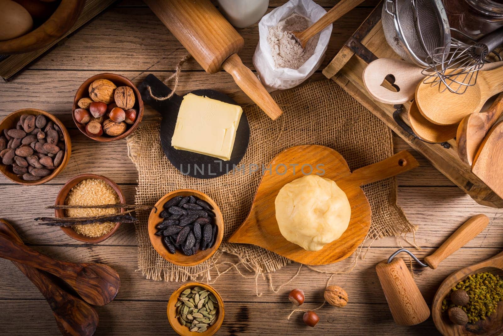 Assortment of baking ingredients and kitchen utensils in vintage wooden style. Christmas baking concept.