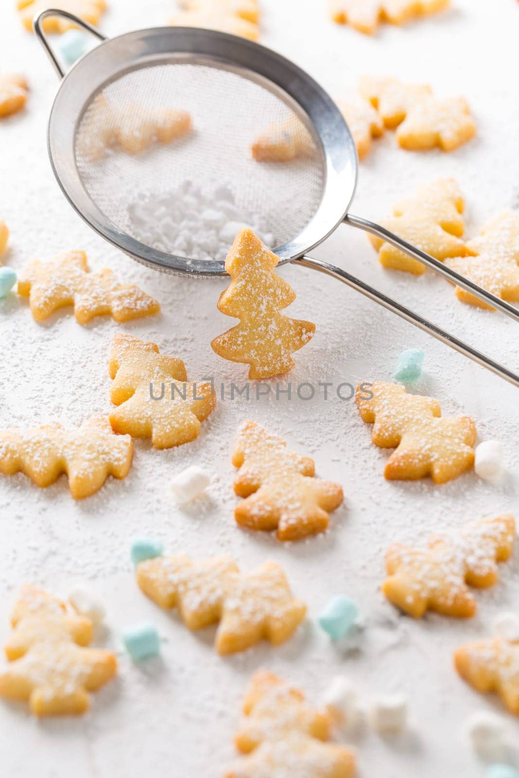 Homemade Christmas cookies in Christmas tree shape on marble background