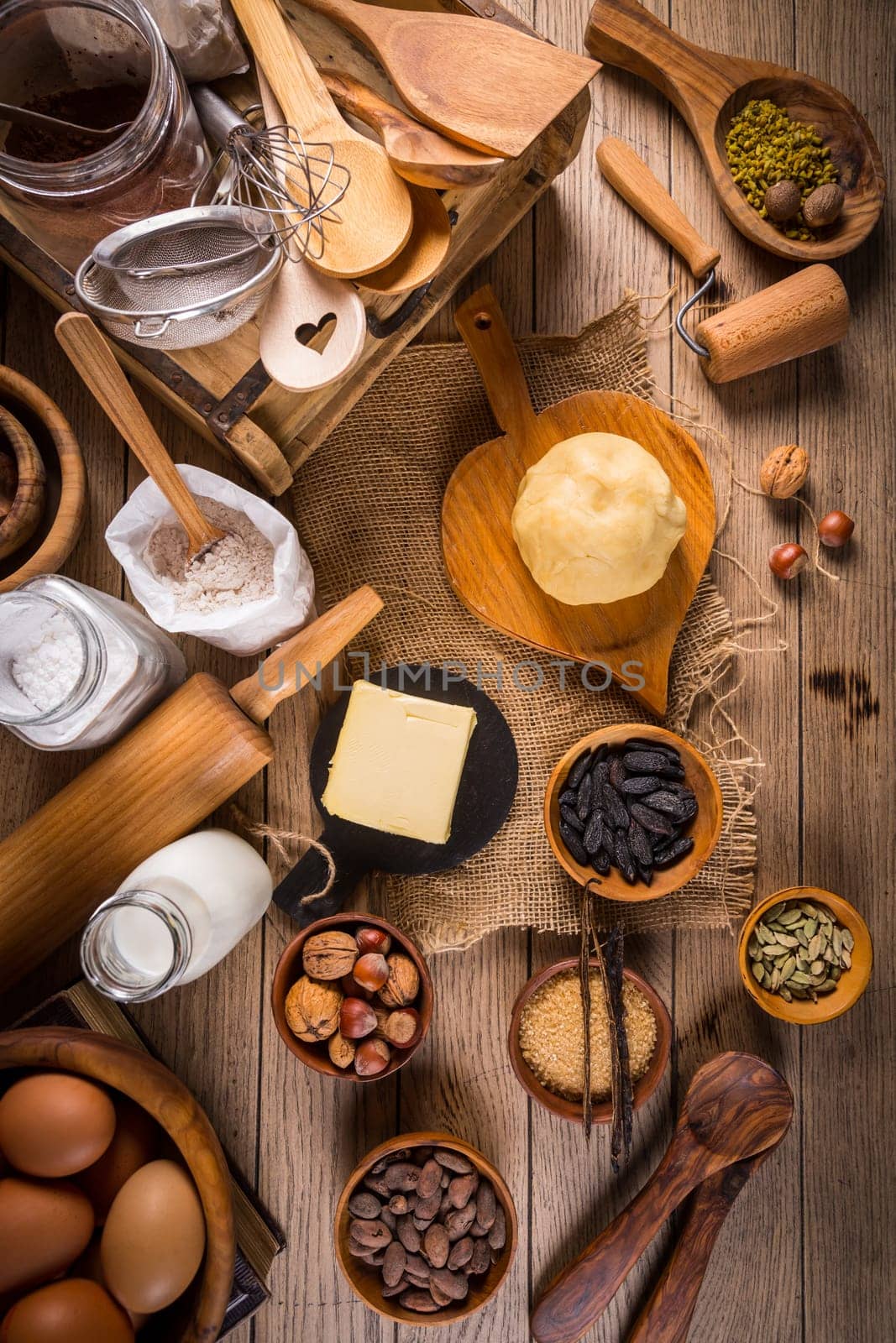 Assortment of baking ingredients and kitchen utensils in vintage wooden style. Christmas baking concept.