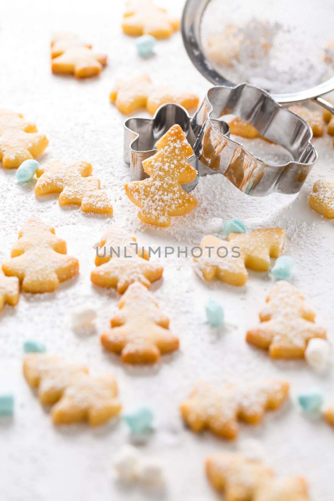 Homemade Christmas cookies in Christmas tree shape on marble background