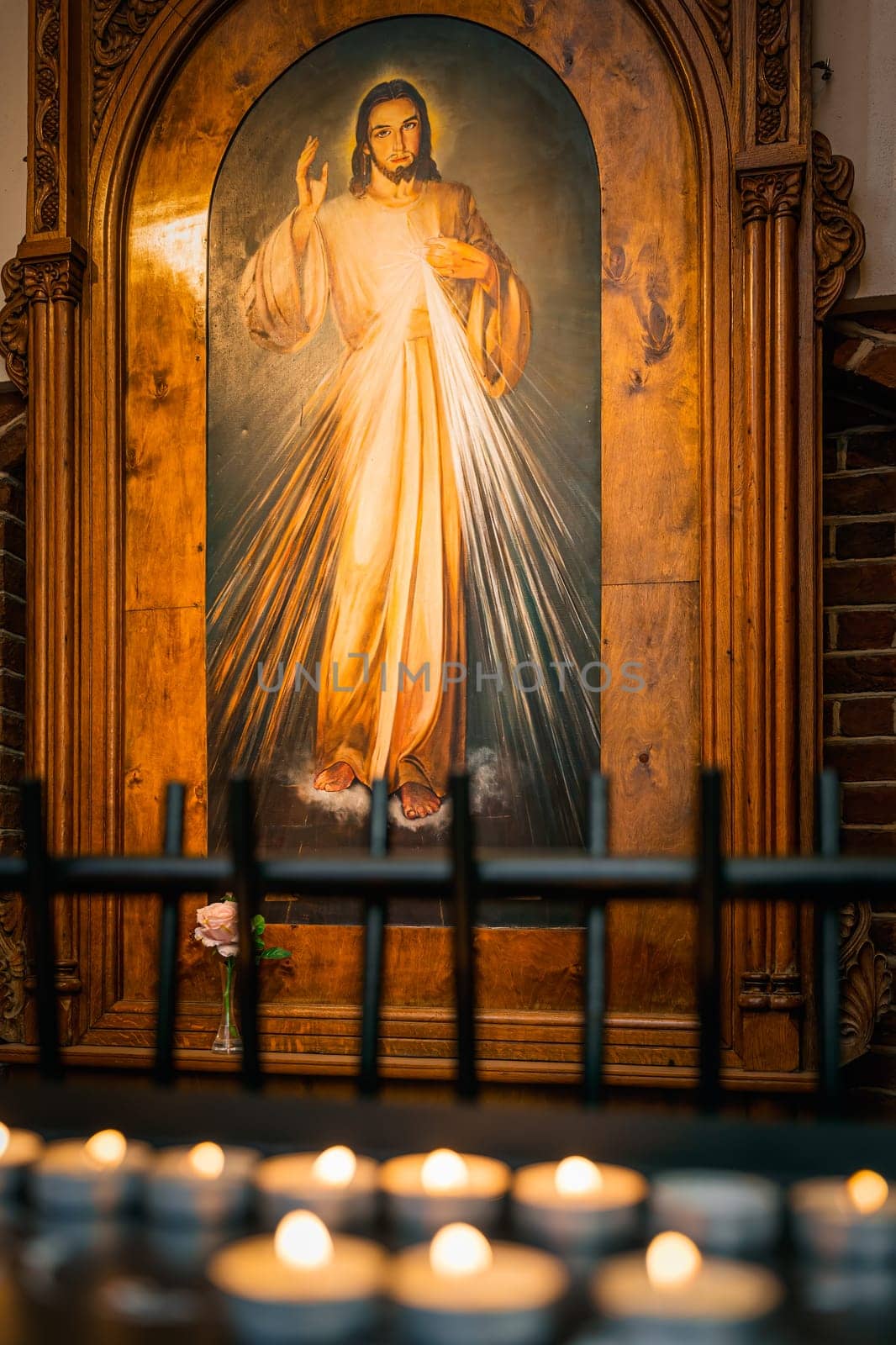 Szczecin, Poland, June 2019 Painting of Yeezus Christ with lit candles in The Cathedral Basilica of St James the Apostle