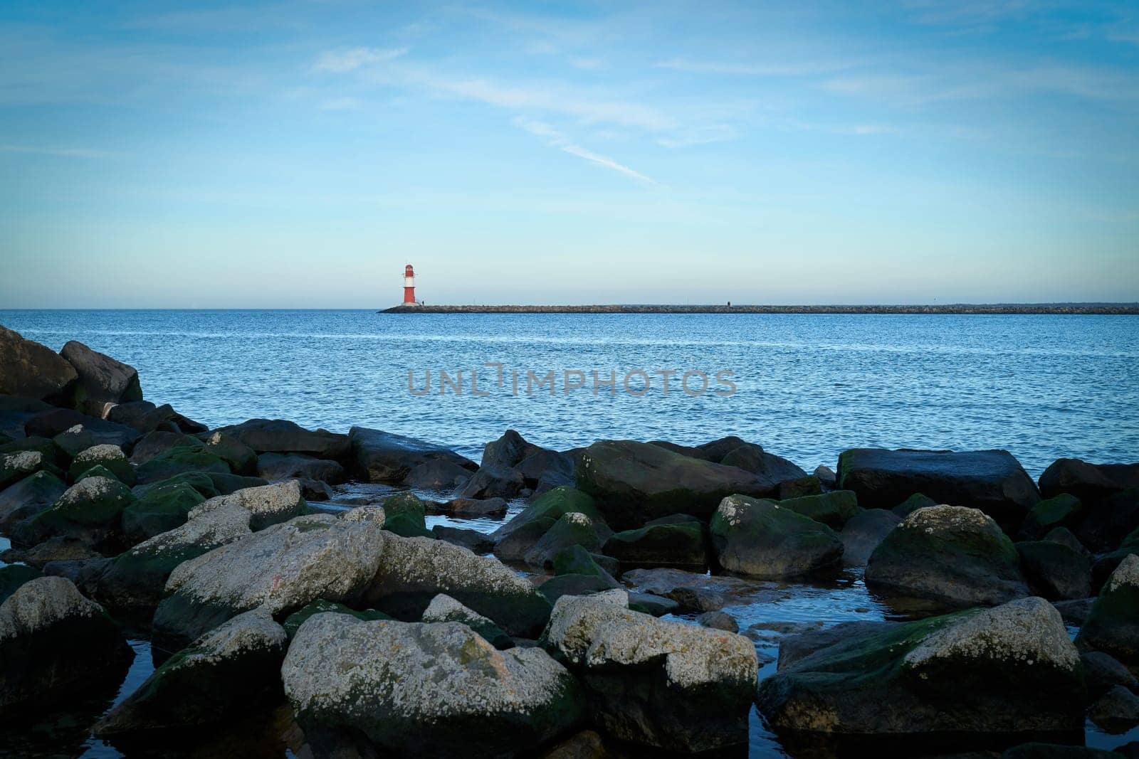 Lighthouse on the east pier on the coast of Warnemuende in Germany