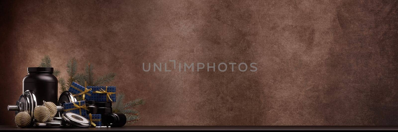 Sports nutrition (supplements), sports equipment, fir branch,  gift boxes, Christmas ornaments on dark brown background with copy space. Fitness, sport, healthy lifestyle concept. New Year. Christmas.