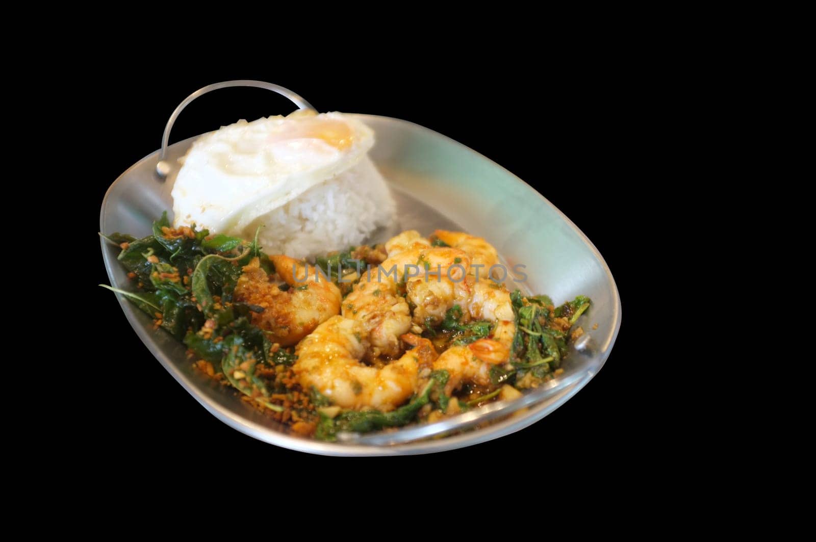 Stirred-fry shrimps or prawns with basil leaves, fried egg over rice. Thai food