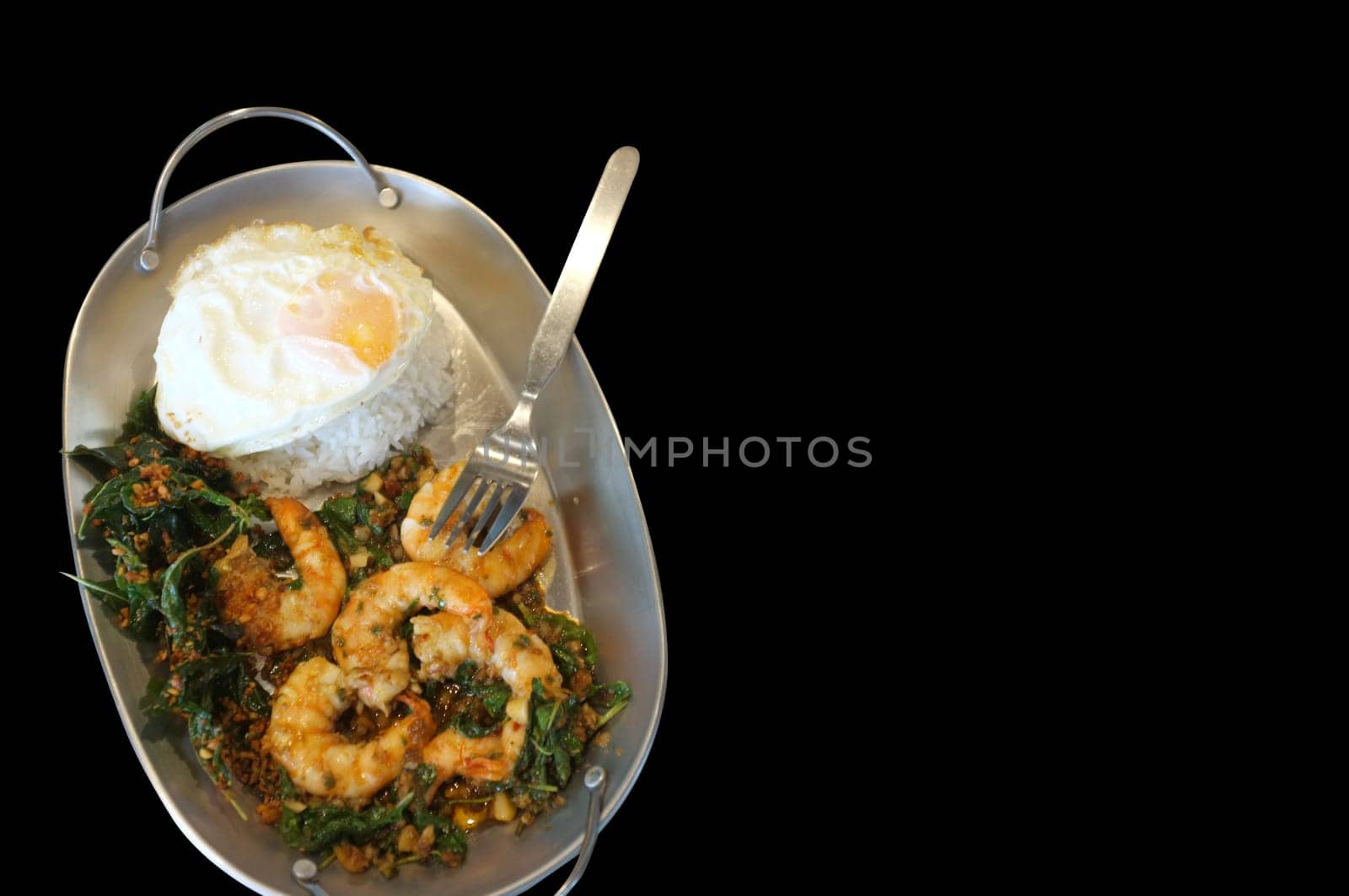Stirred-fry shrimps or prawns with basil leaves, fried egg over rice. Thai food