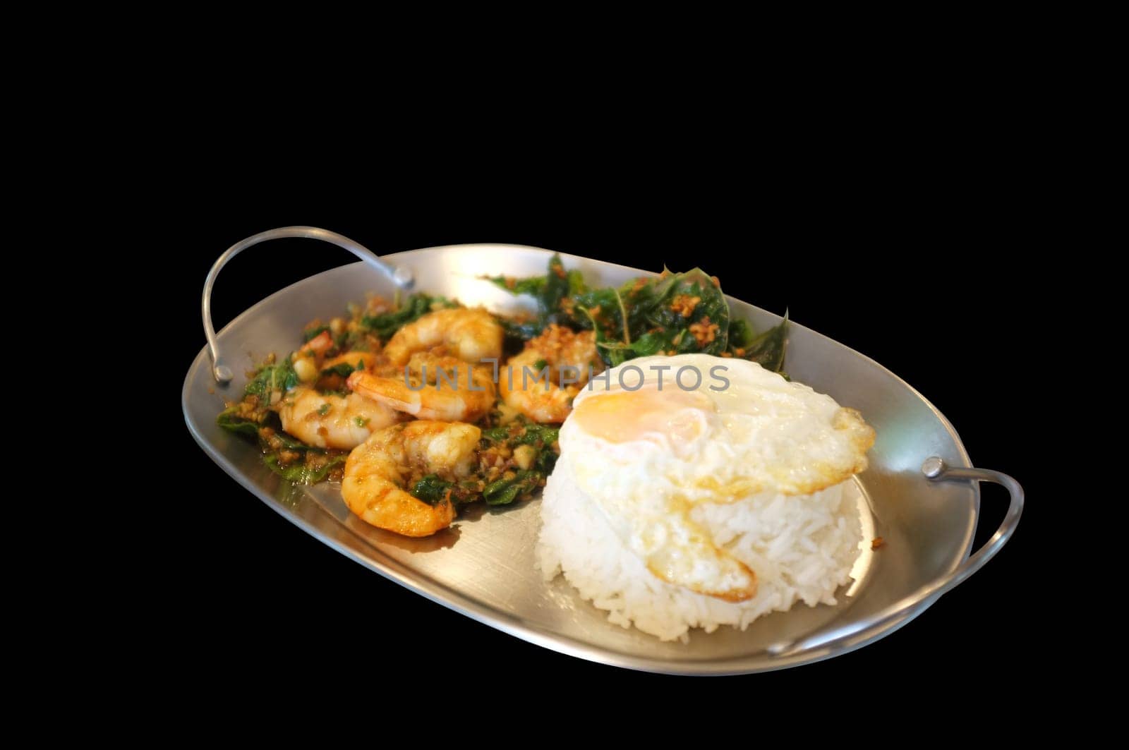 Stirred-fry shrimps or prawns with basil leaves, fried egg over rice. Thai food