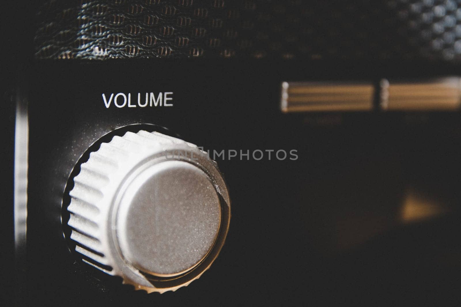 Volume wheel on an old and vintage analog radio. Creative processing for retro looks. Selective focus.