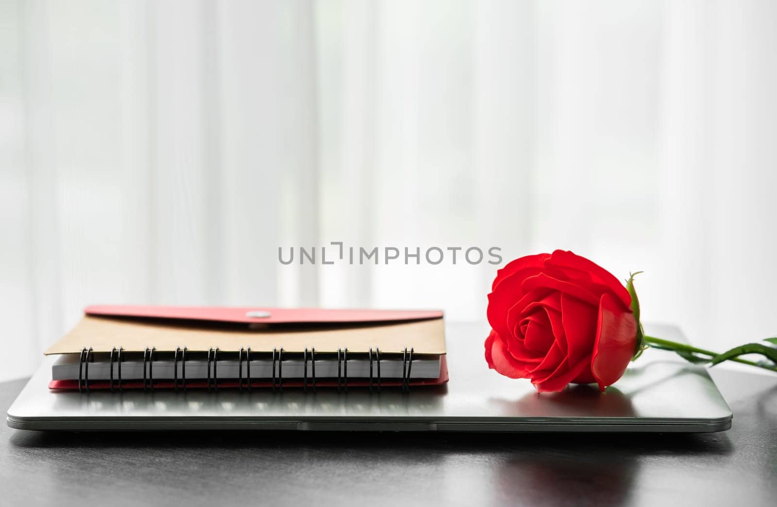 Red rose and the laptop on deck, Valentine concept
