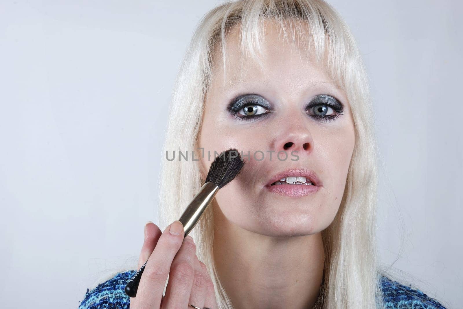 Woman applying makeup