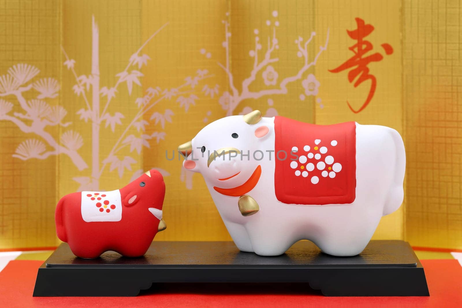 Dolls of Usi Cow. Japanese new year card. Japanese new year cow object. Japanese word of this photography means "celebration or congraturations"""
