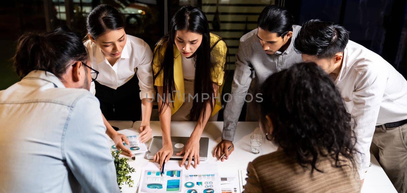 Panorama work late concept of Interracial asian business team brainstorm idea at office meeting room at night. Work hard deadline and overtime working and new business start up concept.
