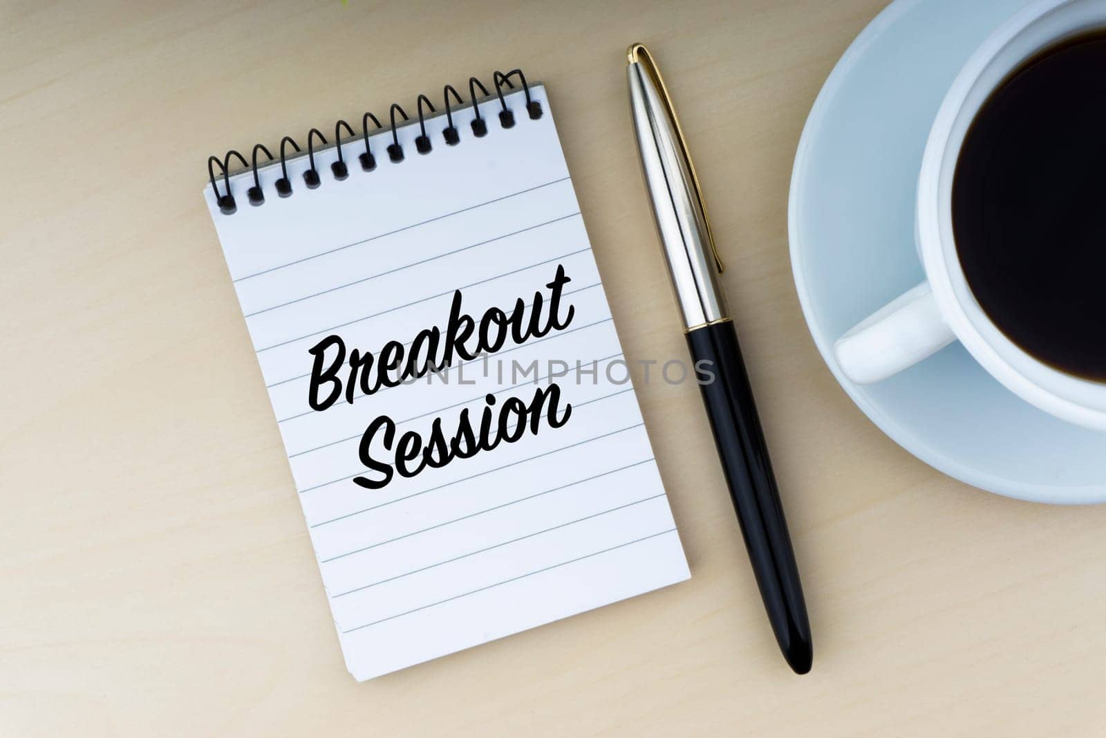 BREAKOUT SESSION text with fountain pen and cup of coffee on wooden background. Business and copy space concept..