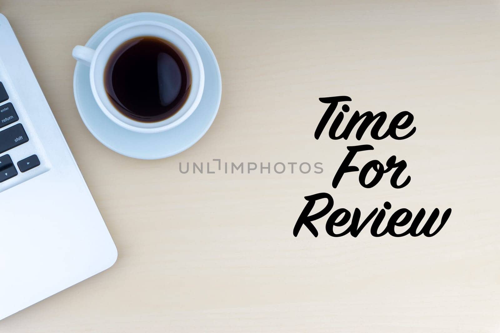 TIME FOR REVIEW text with laptop and cup of coffee on wooden background. Business and copy space concept..