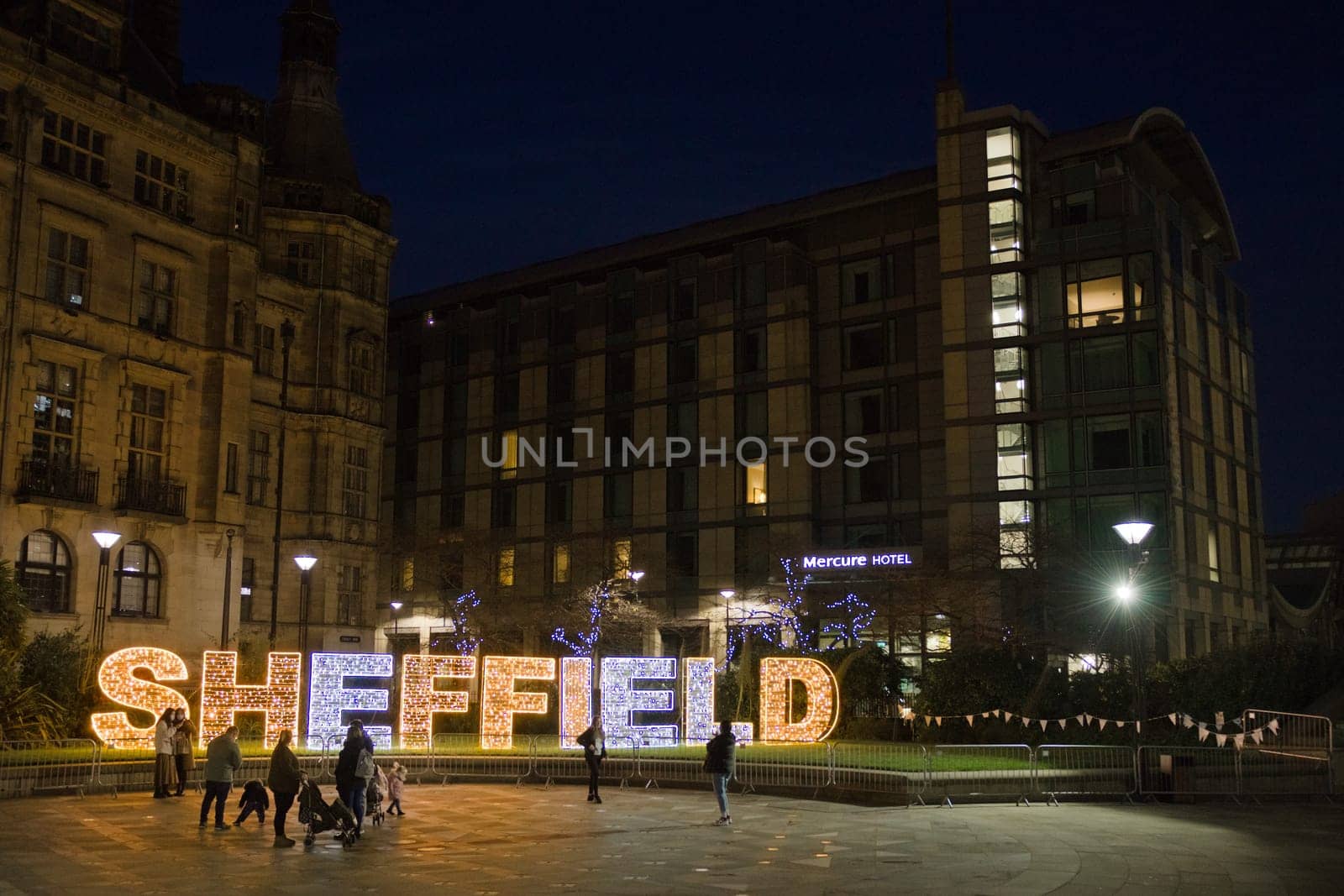 Sheffield, United Kingdom, 27th November, 2020: People taking photos with and enjoying the illuminated sheffield city center christmas lights of 2020