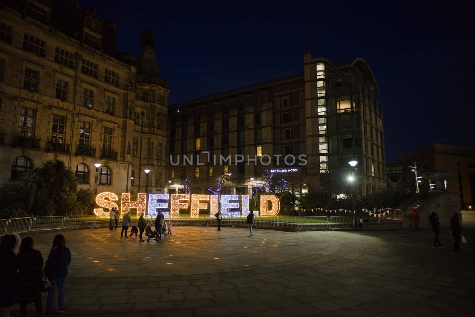 Sheffield, United Kingdom, 27th November, 2020: wide angle image of the peace gardens in sheffield city center with people enjoying christmas lights
