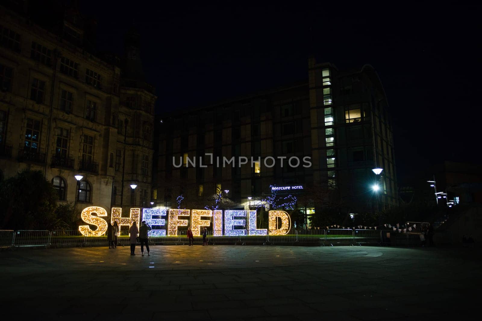Sheffield, United Kingdom, 27th November, 2020: A few people admire the sheffield christmas lights during the 2nd Covid lock down. Peace garden area