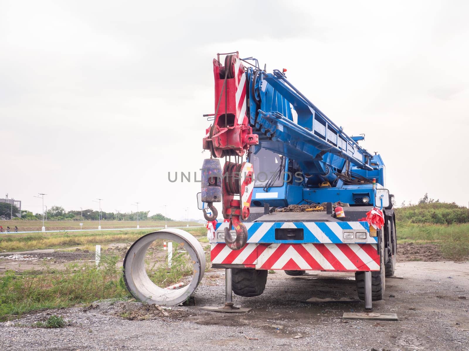 Construction site crane is lifting a led signboard Blank billboard on blue sky background for new advertisement