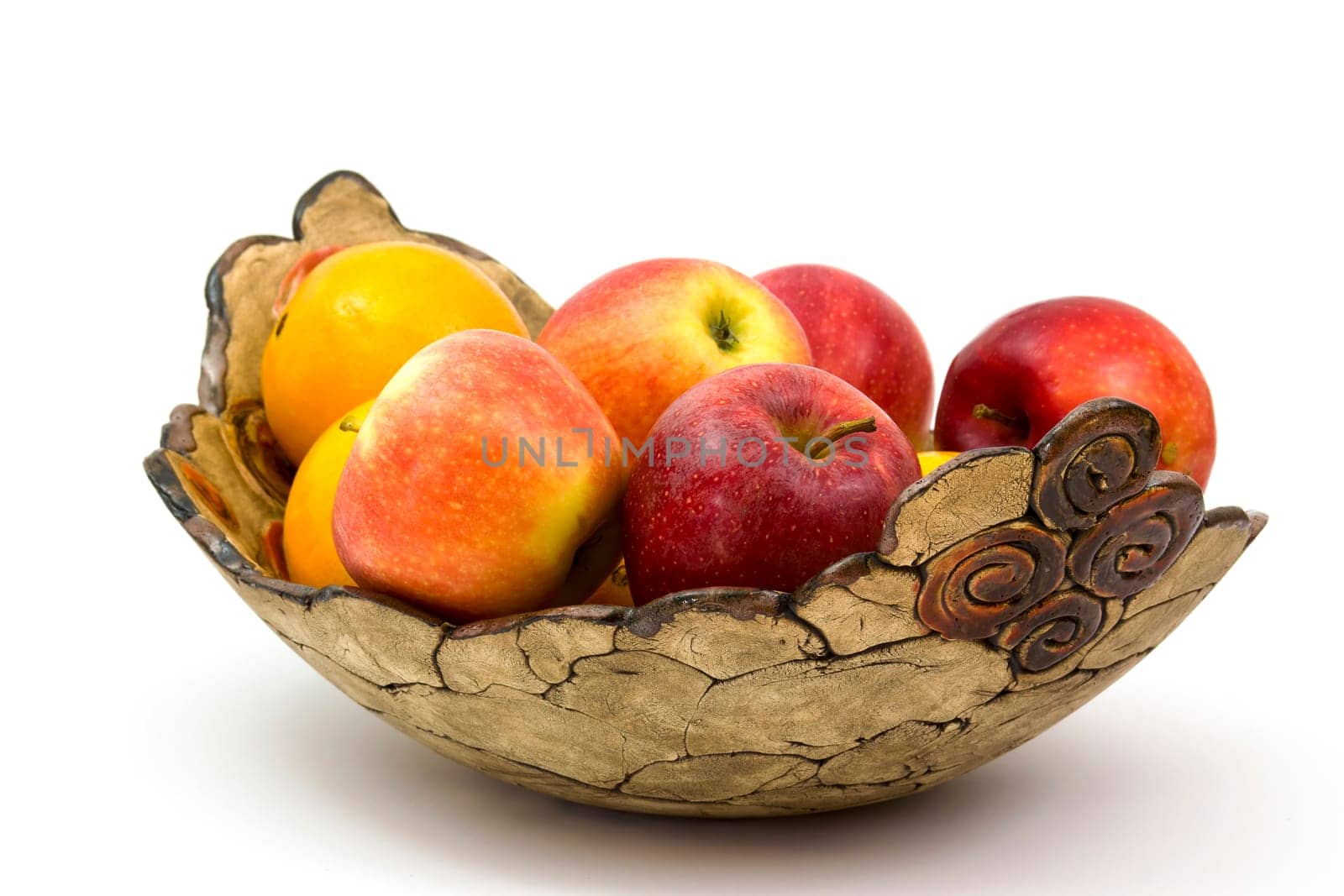 fresh fruits in a clay bowl - oranges and apples