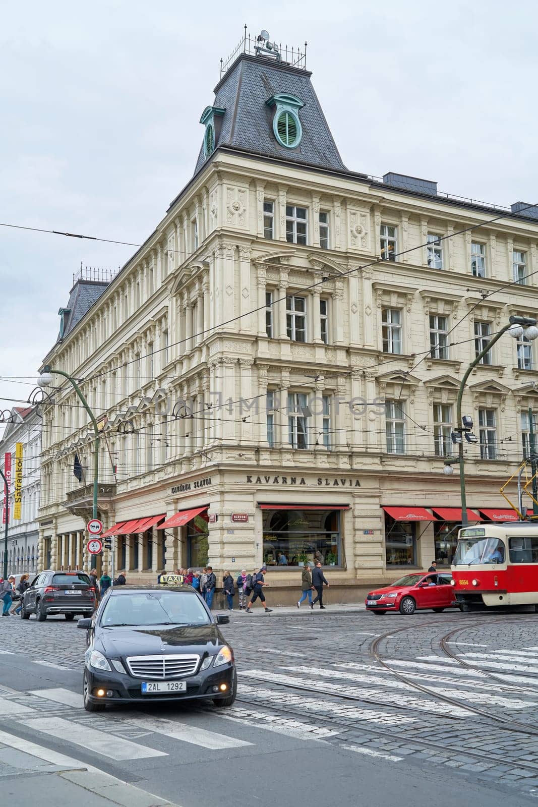 Rush hour in front of the famous Cafe Slavia in the centre of Prague, popular especially with artists
