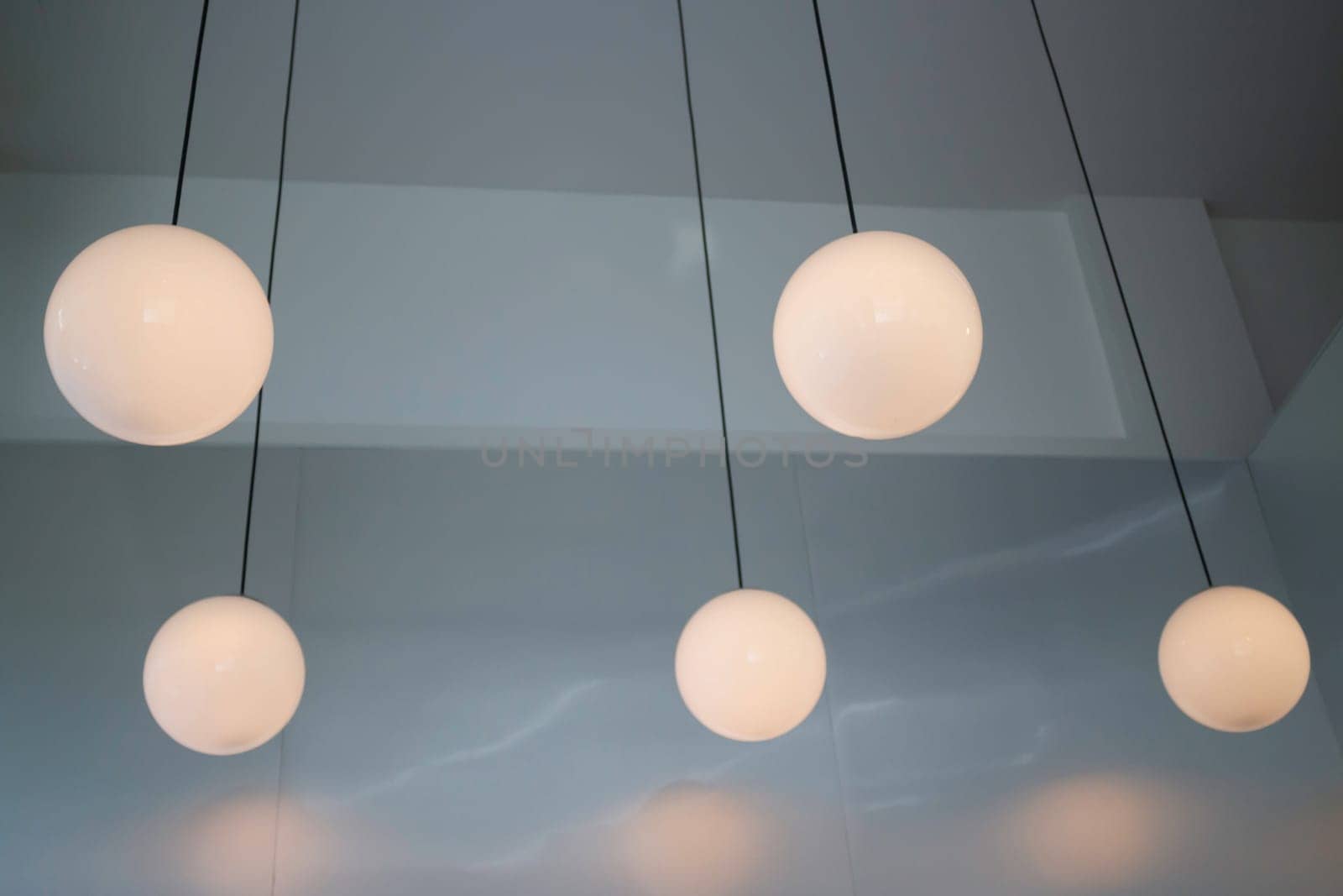 Lamp hanging in a dark room, stock photo