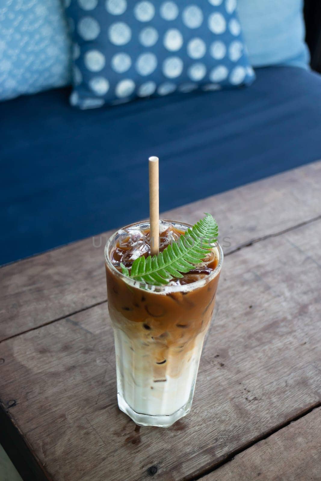 Coffee glass decorated with fern leaf, stock photo