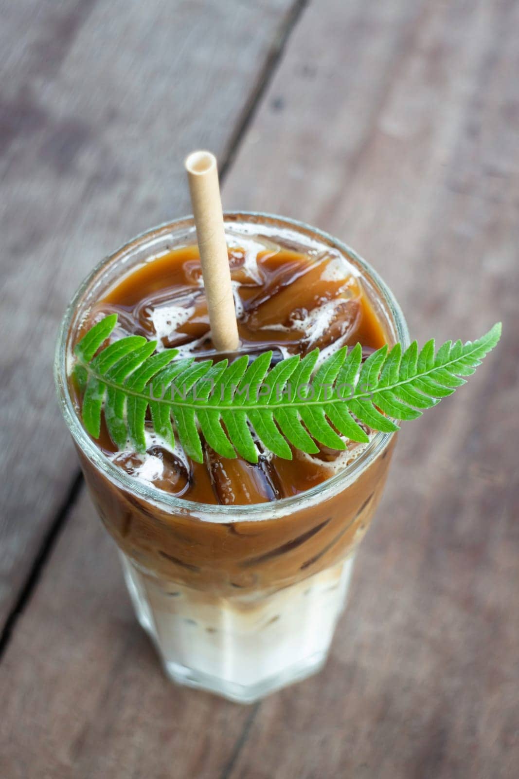 Coffee glass decorated with fern leaf, stock photo