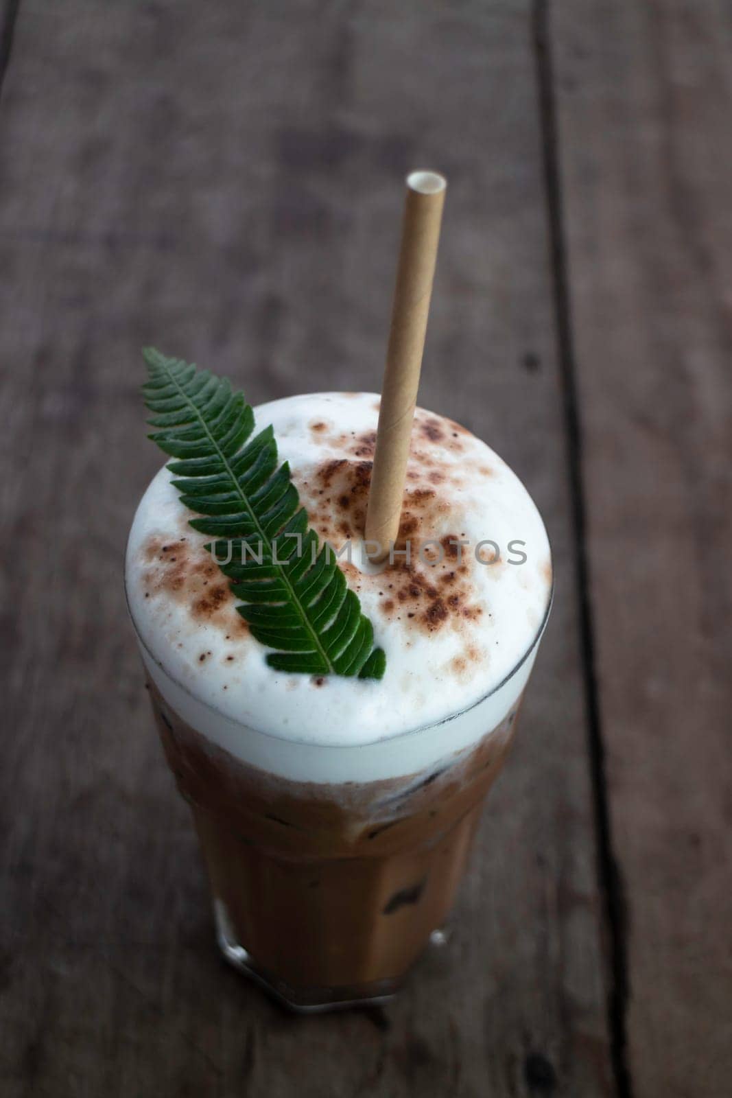 Coffee glass decorated with fern leaf, stock photo