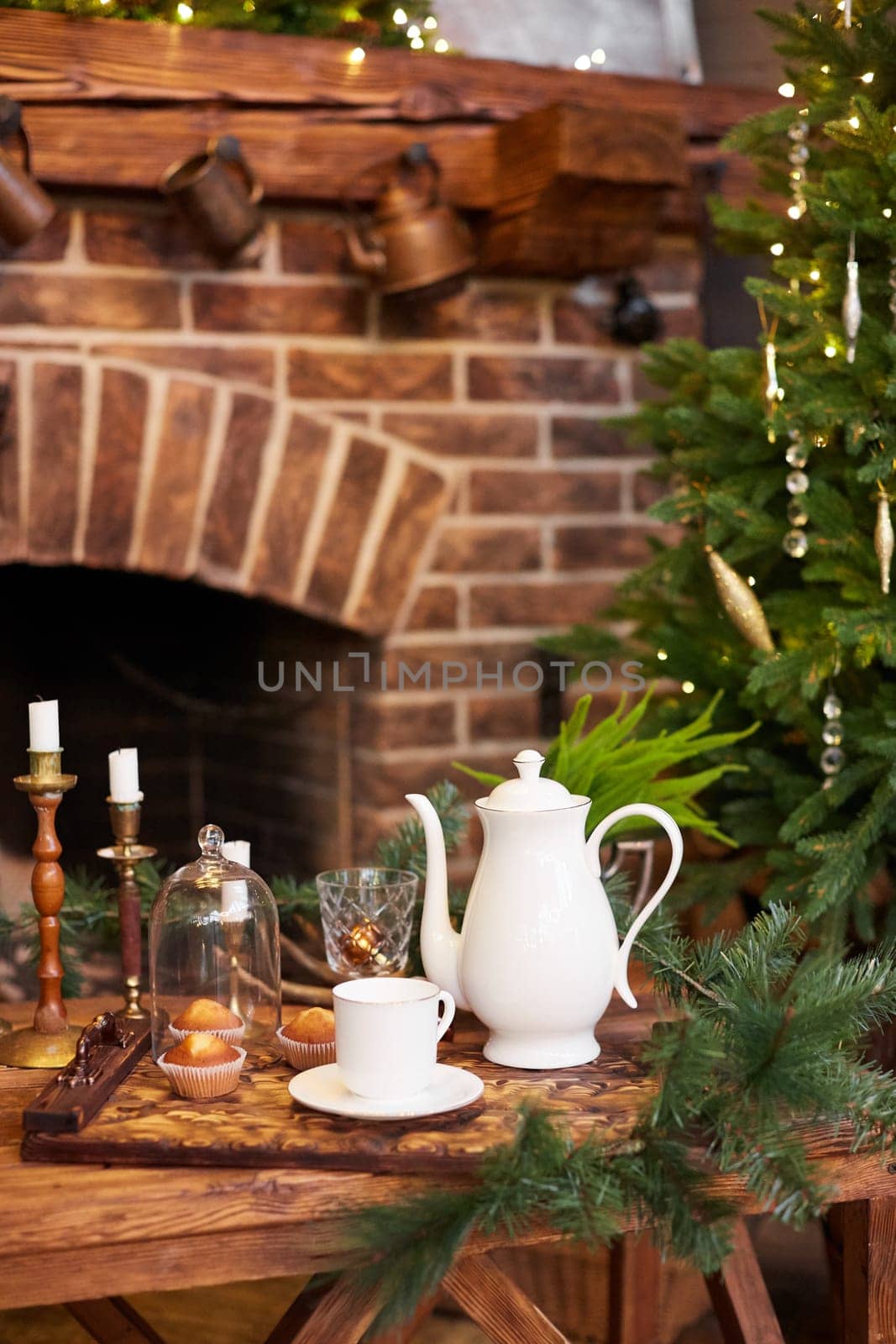 Home Christmas decoration interior late in night with light on xmas tree and fireplace.