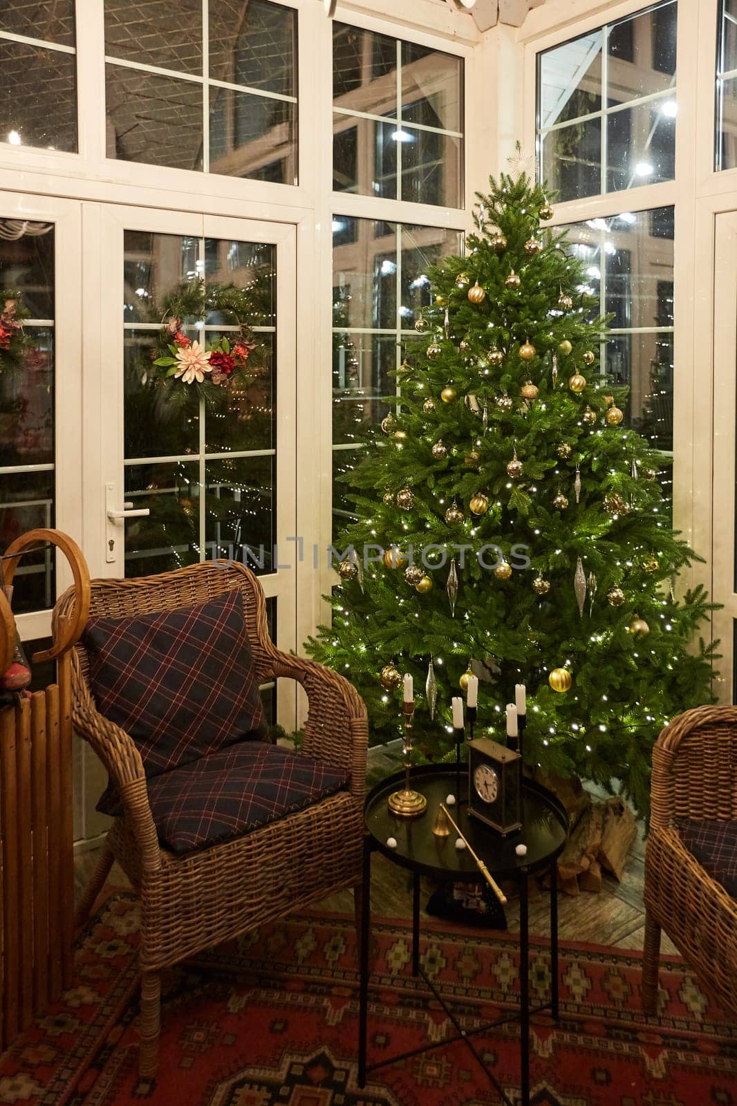 Home Christmas decoration interior late in night with light on xmas tree and gifts.
